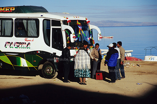 A recently consecrated new bus, a crate of beer is pleasantly drank in the morning in convivial company to celebrate it