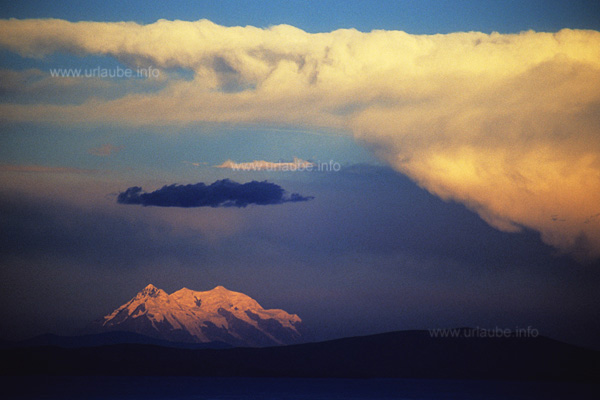 At a distance of 180 kilometer, the Illimani shines in the evening light.