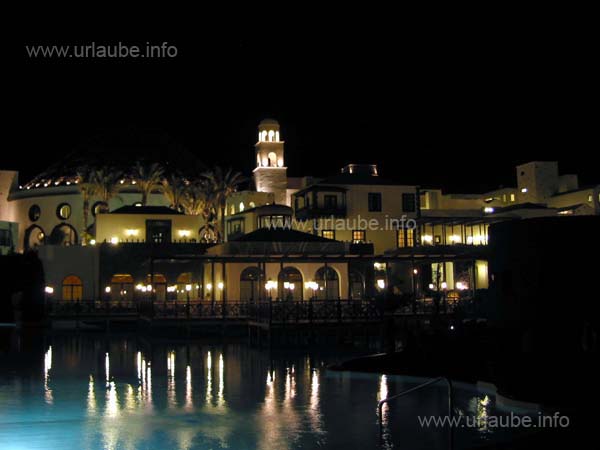 Hotel complex with the spire and swimming pool at night