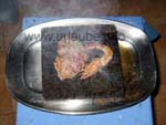 Preparation of a fillet of beef and a prawm on a hot stone right at the table