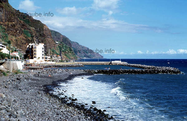 The hotel with the beach area that is divided by big boulders