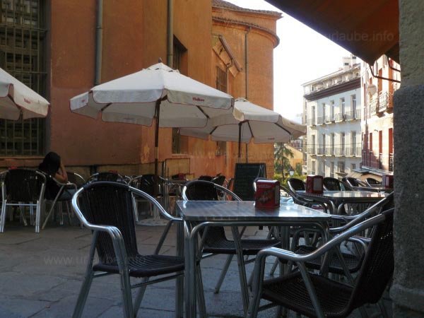 In the mornings, the seats in the bars that surround the church are still free