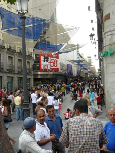 A lot of people everywhere, specialy during the summer sales period. In the background there is the advertisement of El Corte Ingl&eacute;s; up to 50% discount for clothes.