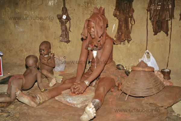 Himba woman making the red paste