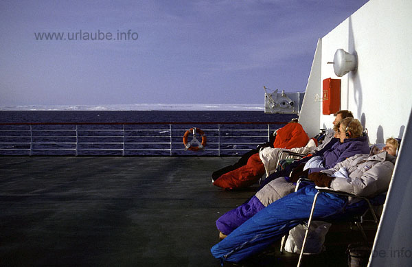 Alongside the snowy Finnmark coast. The weather is like in a Mediterranean Sea cruise, but only a little colder!