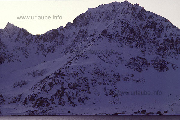Entering into the &Ouml;ks fjord. Houses at the bottom of the massive peak of Loppa