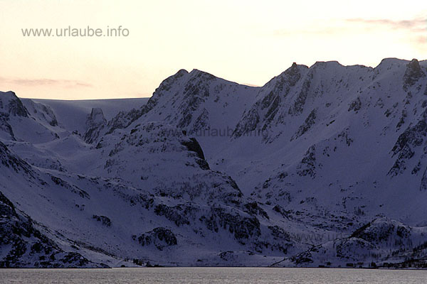 At the left of the picture in the last evening light, the apophysis of the 1204 m heighted &Ouml;ksfjord glacier