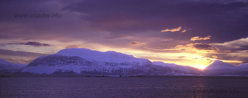 Sun rise above the island Rolla. View from the Hurtigruten dock in Harstad over the Vags fjord.