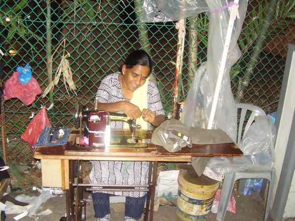 An Indian woman sewing amidst the Serangoon Road