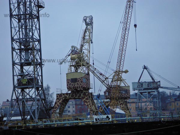 Two cranes painted like a giraffe
