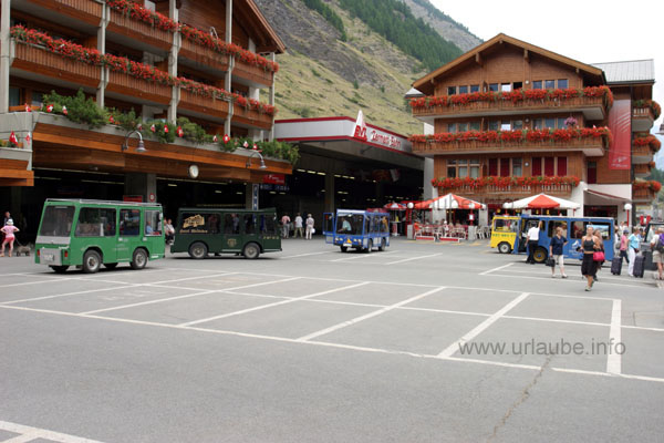 Station sqare of Zermatt; attention is to be paid to the little electric cars